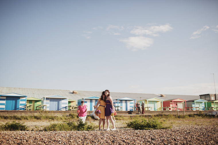 Wedding Photographer in Kent Maria and John (11 of 15) Two bridesmaids hugging on Whitstable beach, Kent