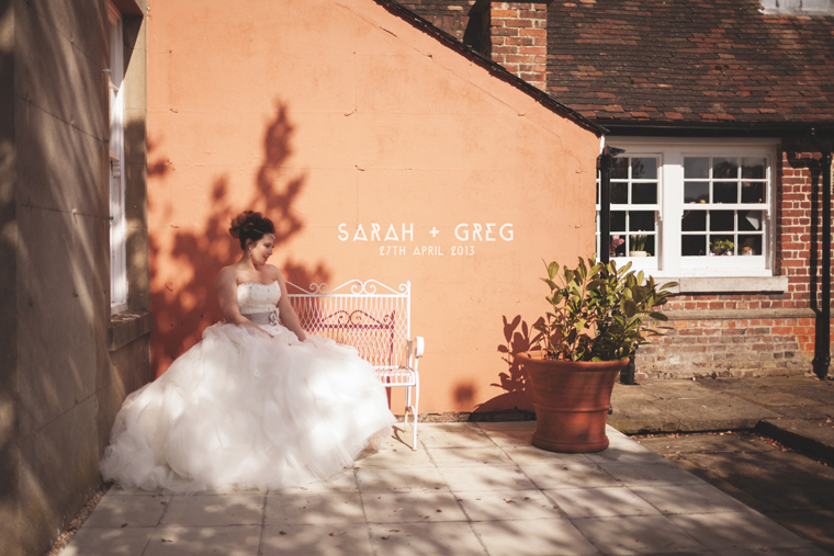 Image of bride against orange wall, shot by London Wedding Photographer at Swarling Manor Kent